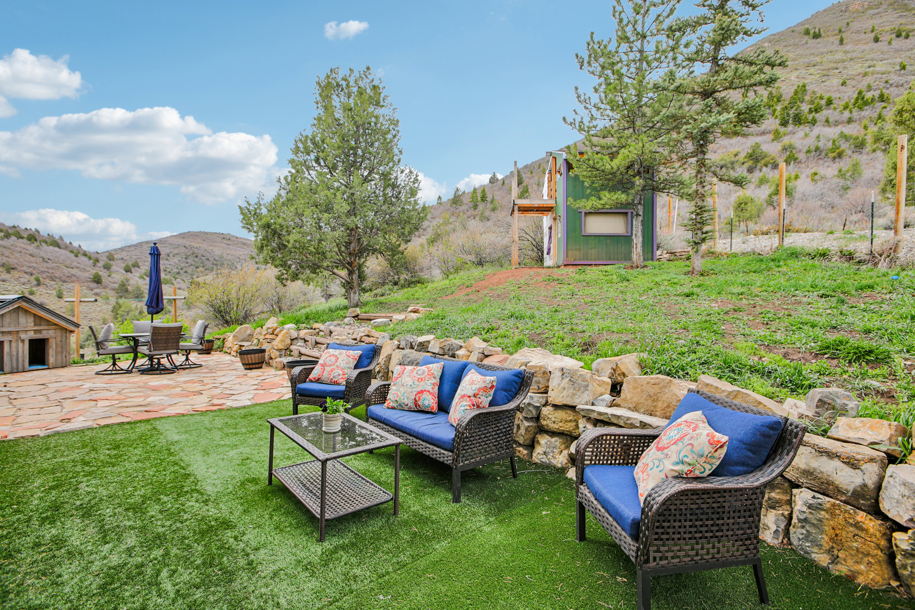 View of grassy yard with a mountain view, a patio, and outdoor lounge area