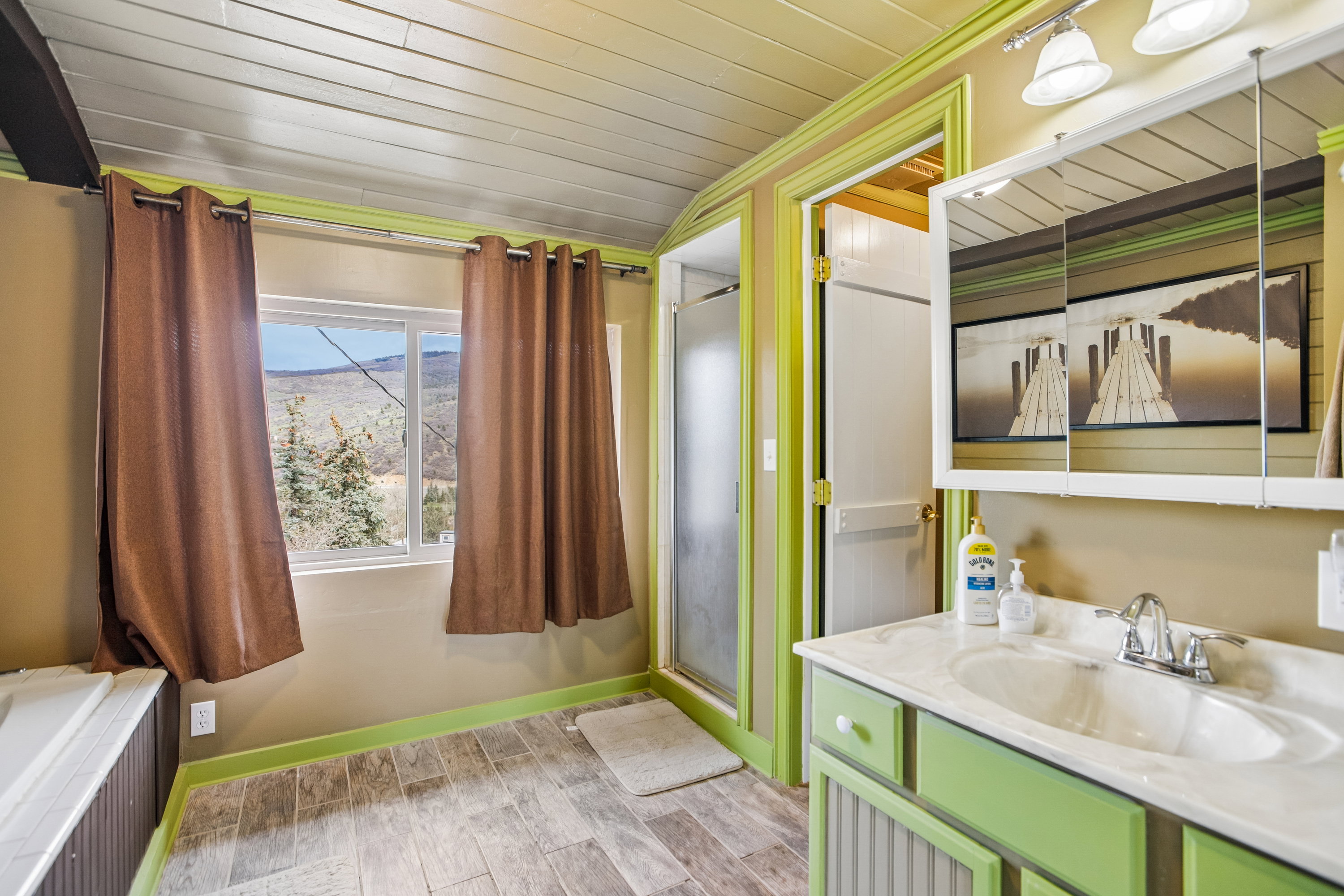 Bathroom featuring vanity, wood finish floors, and wood ceiling