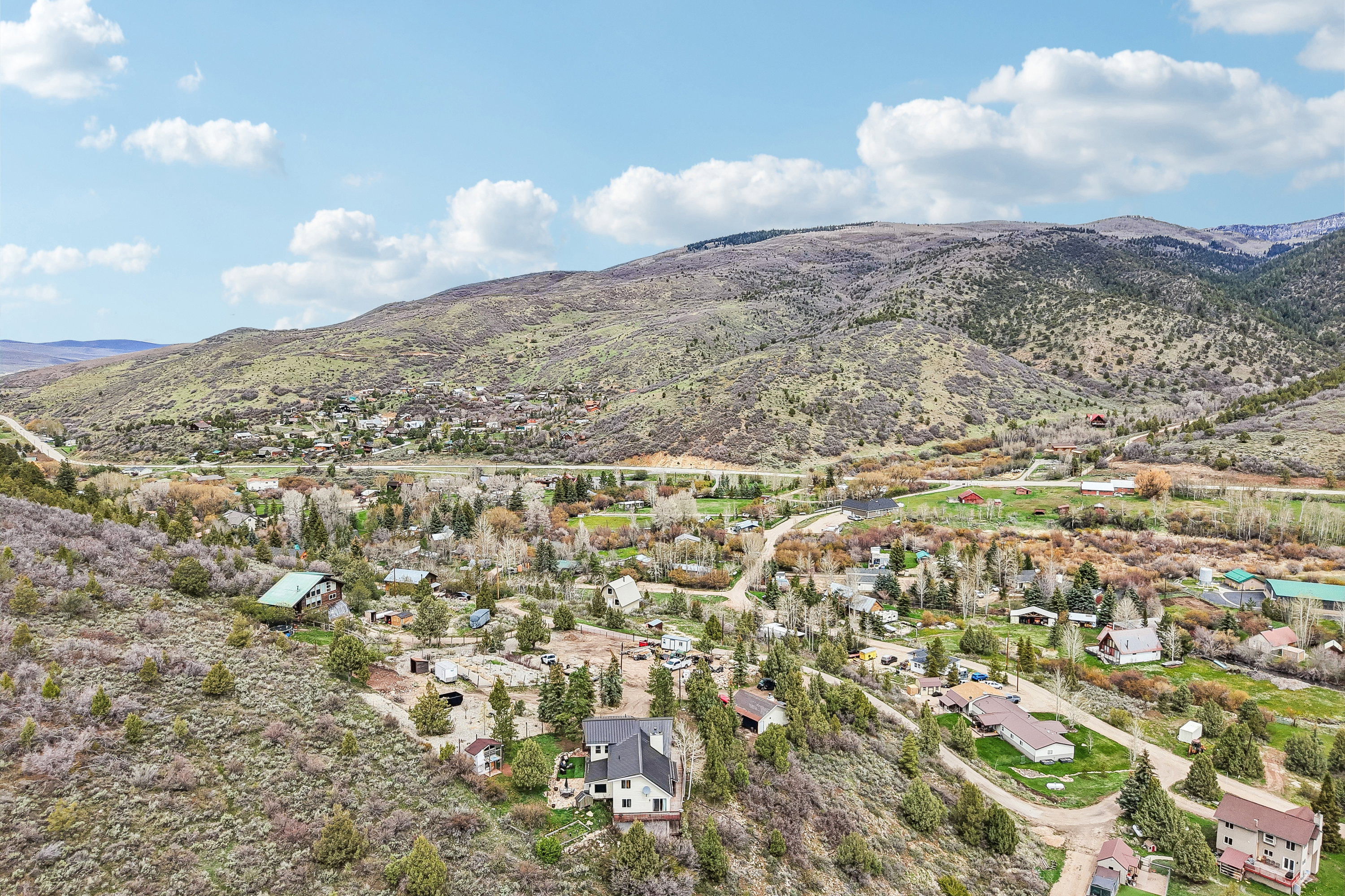 Aerial perspective of suburban area with a mountainous background