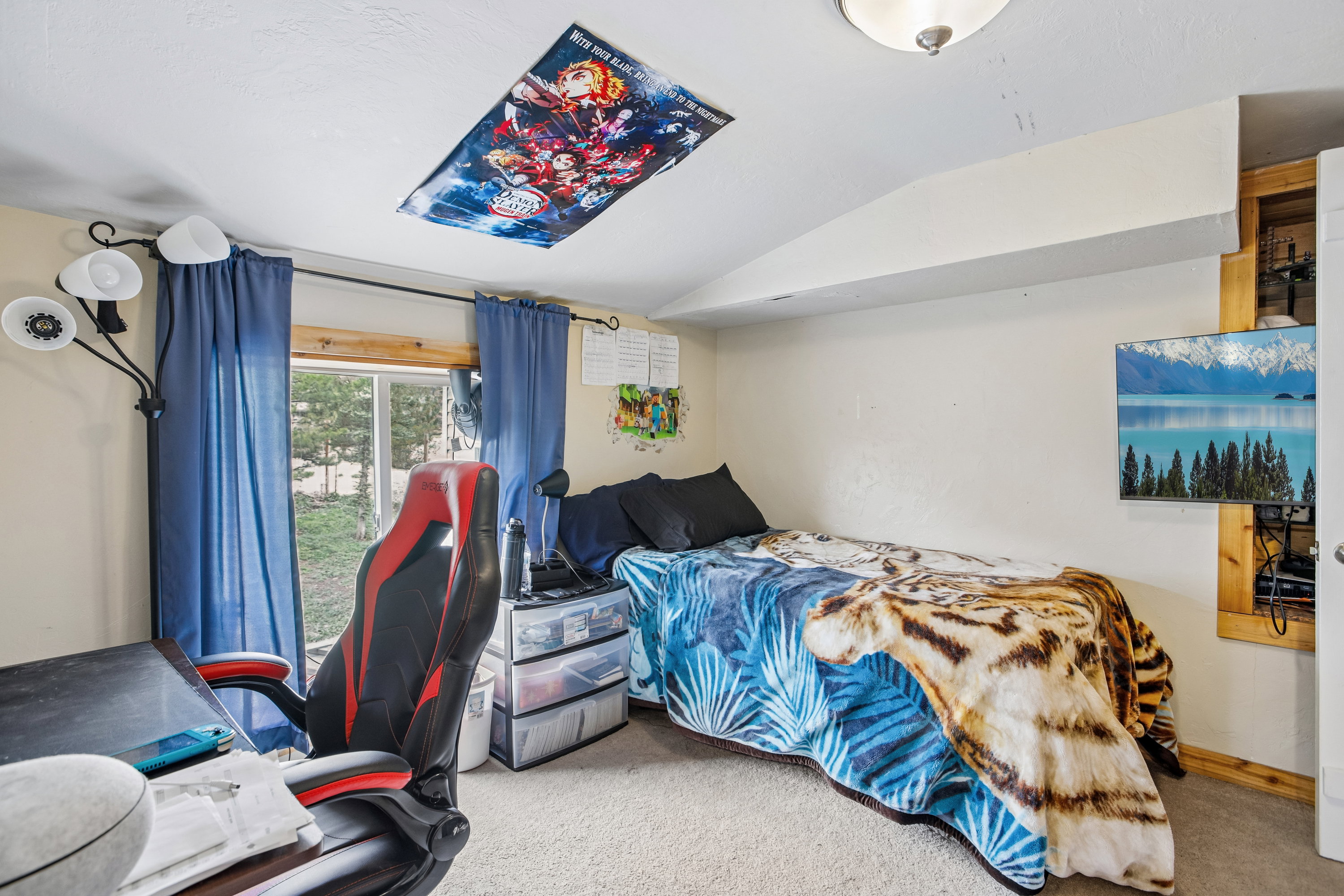 Carpeted bedroom with lofted ceiling