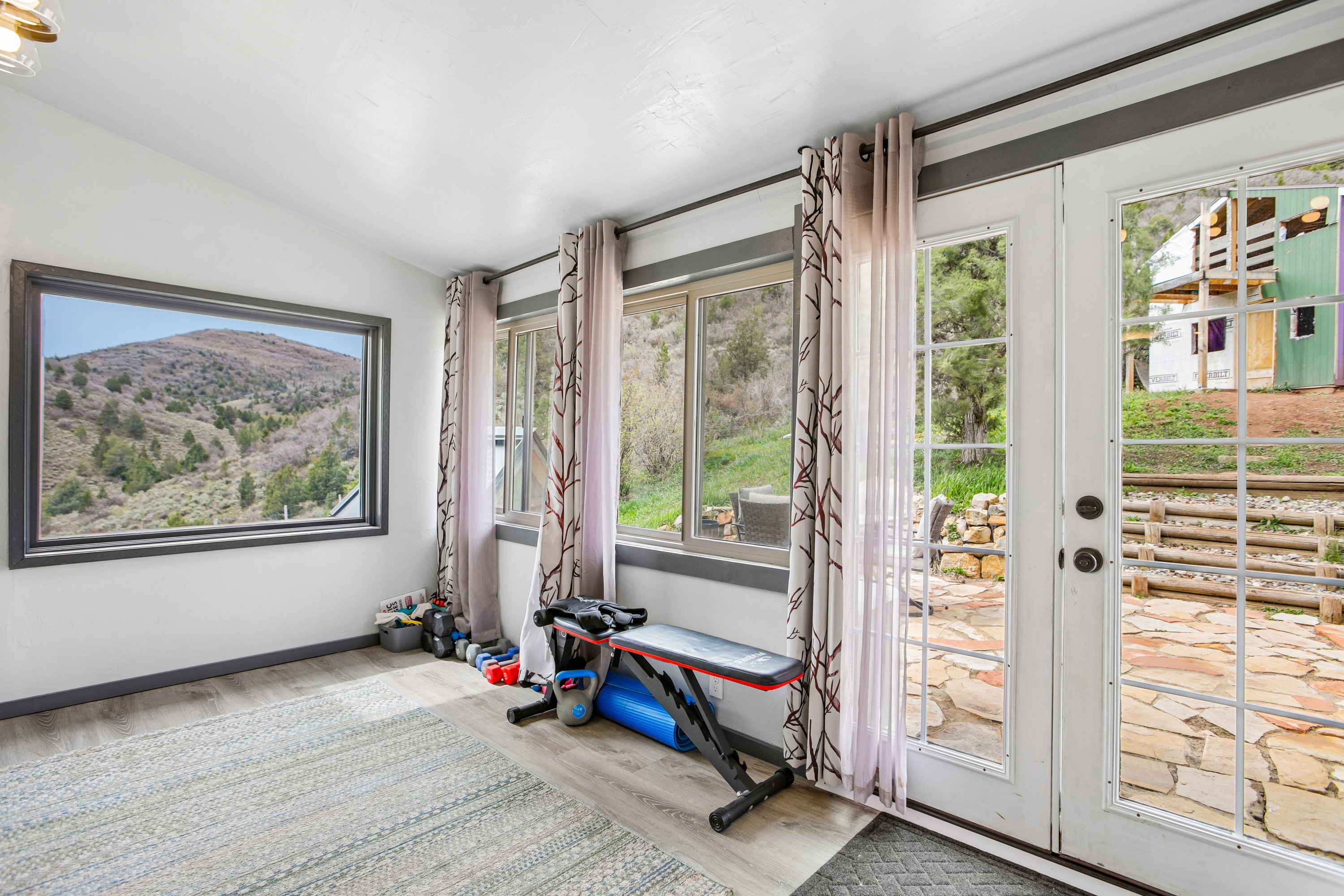 Entryway featuring vaulted ceiling, wood finished floors, and a mountain view