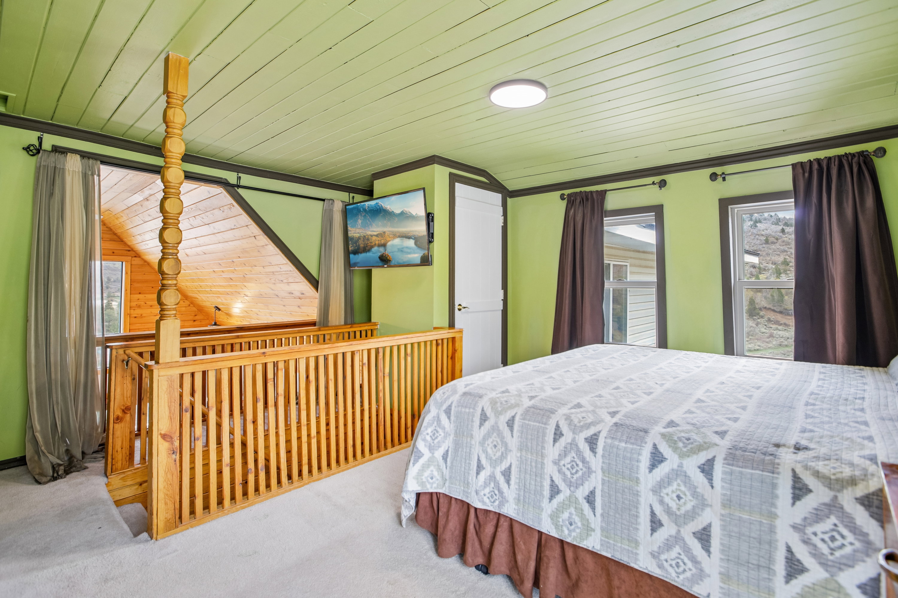 Carpeted bedroom featuring a vaulted wood ceiling