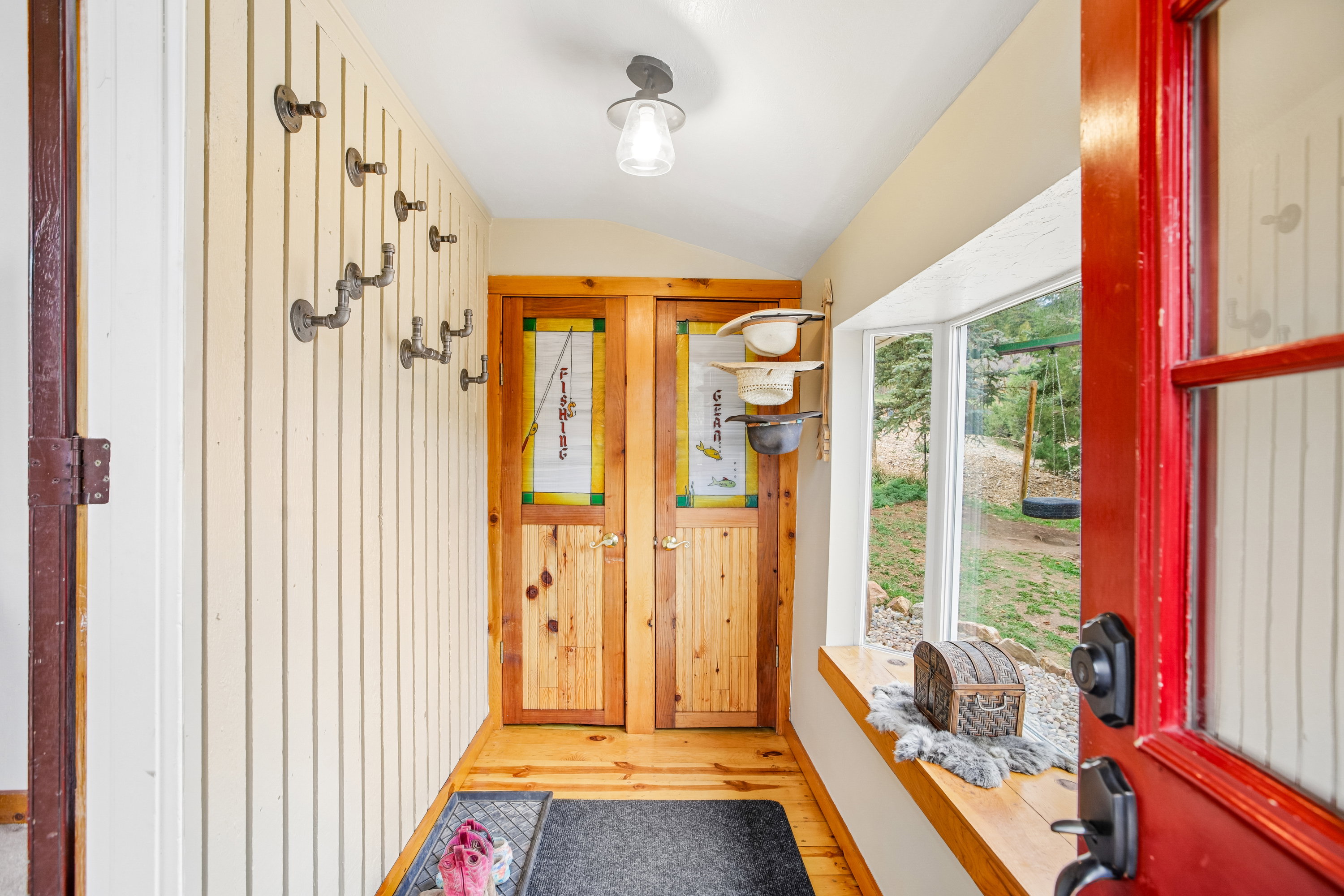 Doorway to outside featuring vaulted ceiling and wood finished floors
