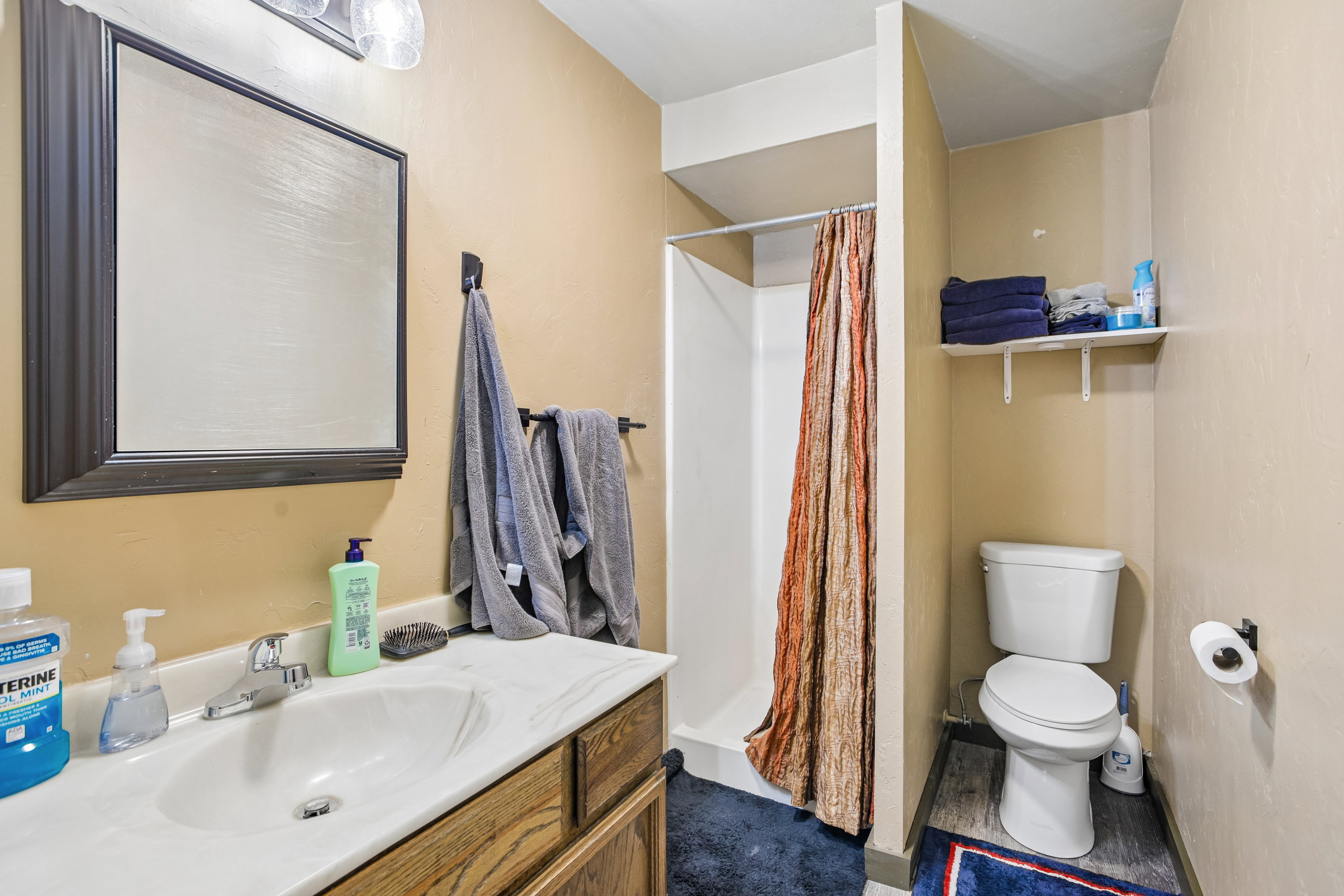Full bath with a stall shower and vanity