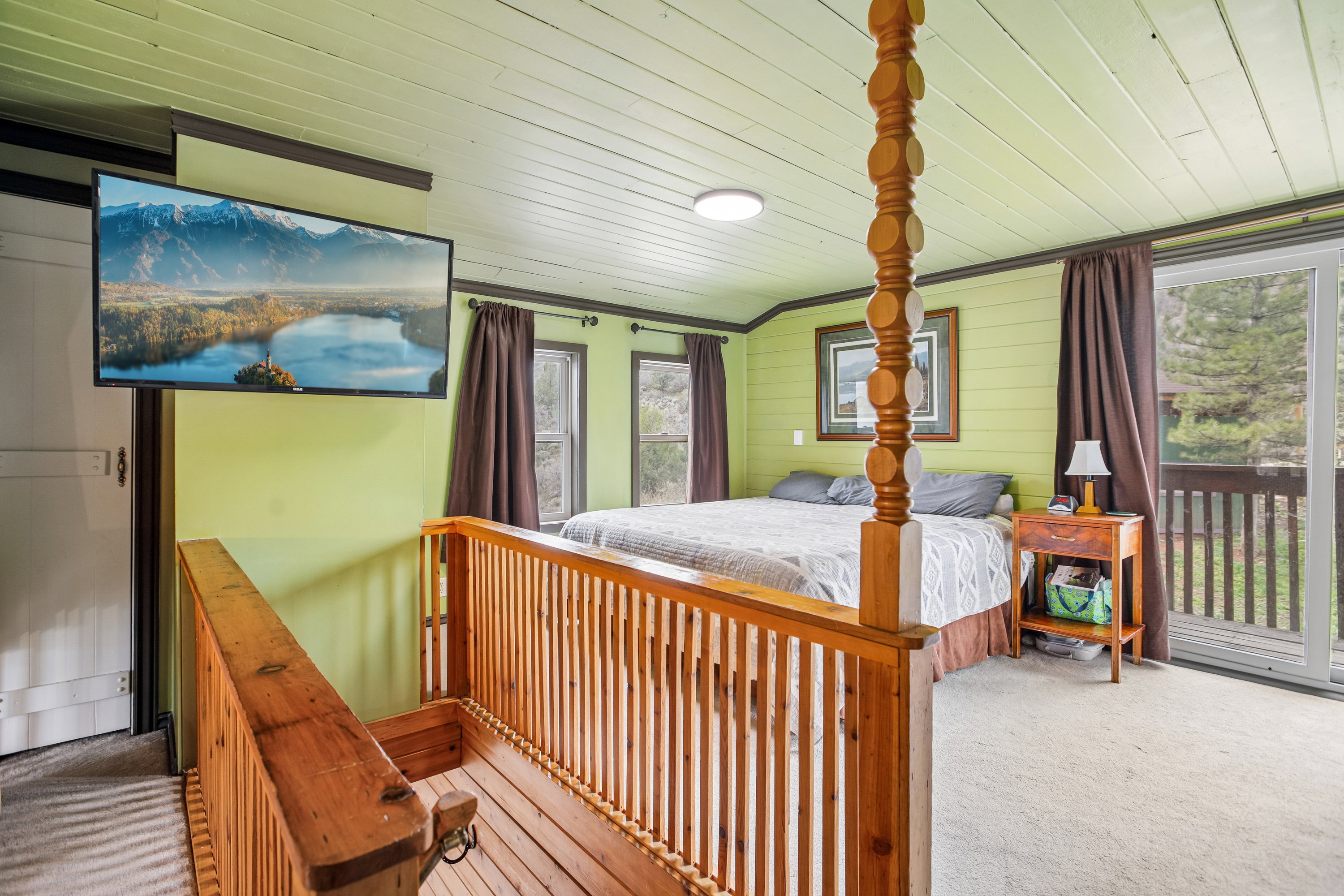 Bedroom featuring carpet, wood walls, access to outside, and wood ceiling