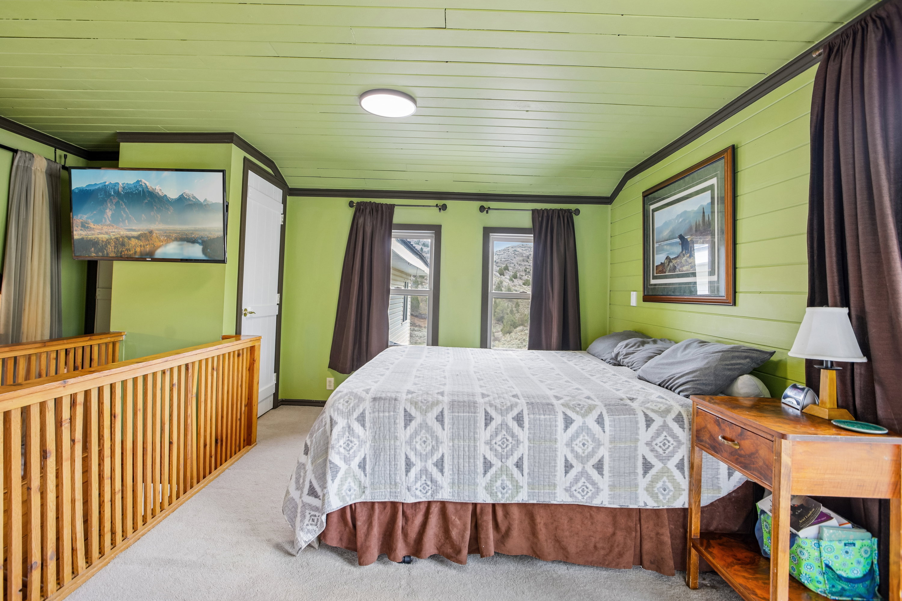 Carpeted bedroom with wooden walls, ornamental molding, and wooden ceiling