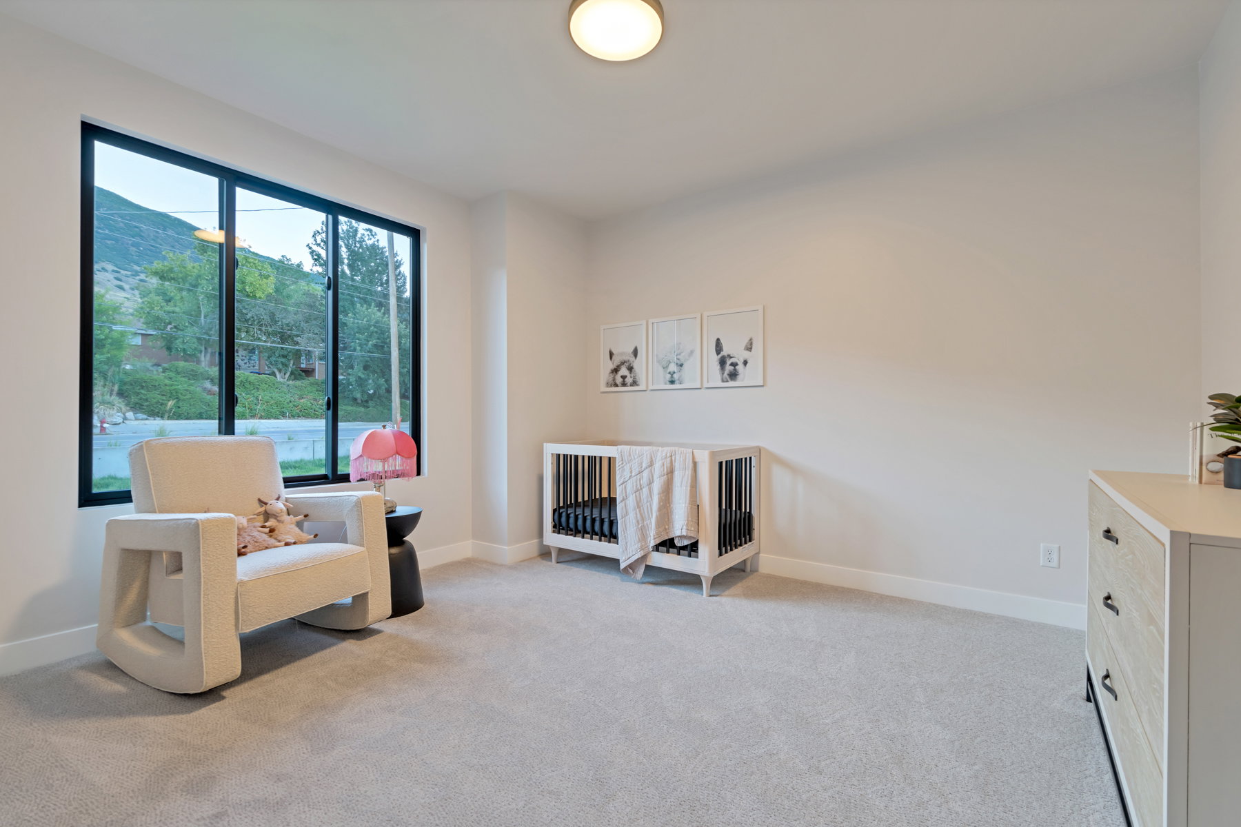 Living area featuring light colored carpet and a mountain view