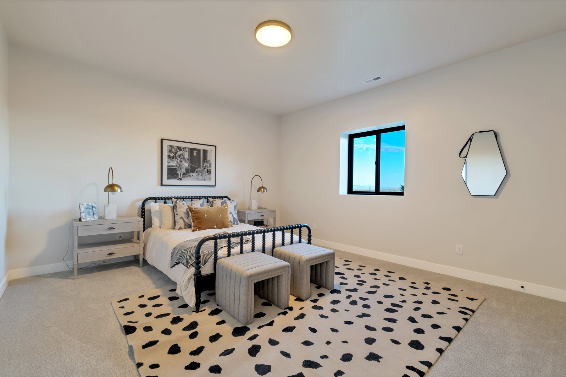 Bedroom with light colored carpet and baseboards