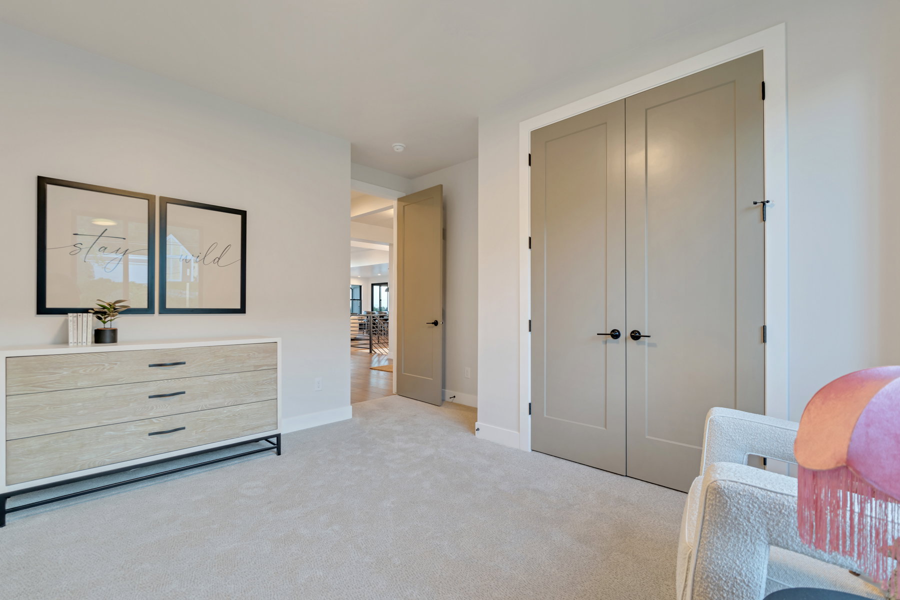 Bedroom featuring light carpet and a closet
