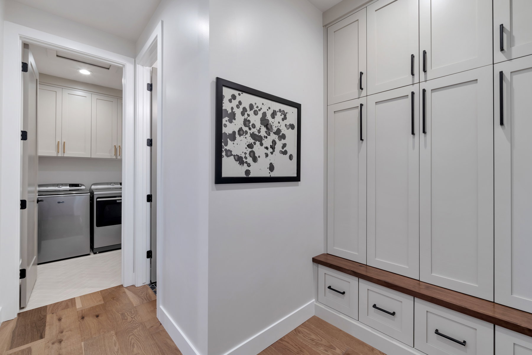Mudroom featuring light wood-style floors, independent washer and dryer, and recessed lighting