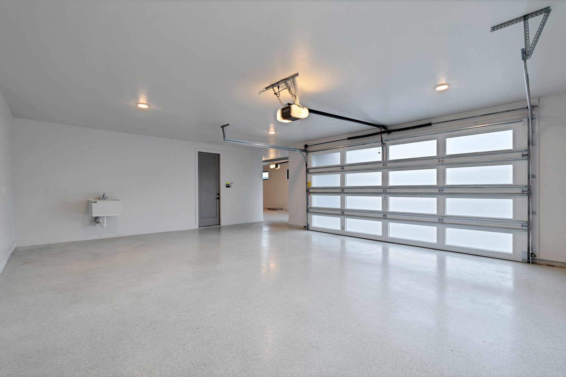 Garage with a sink and a garage door opener