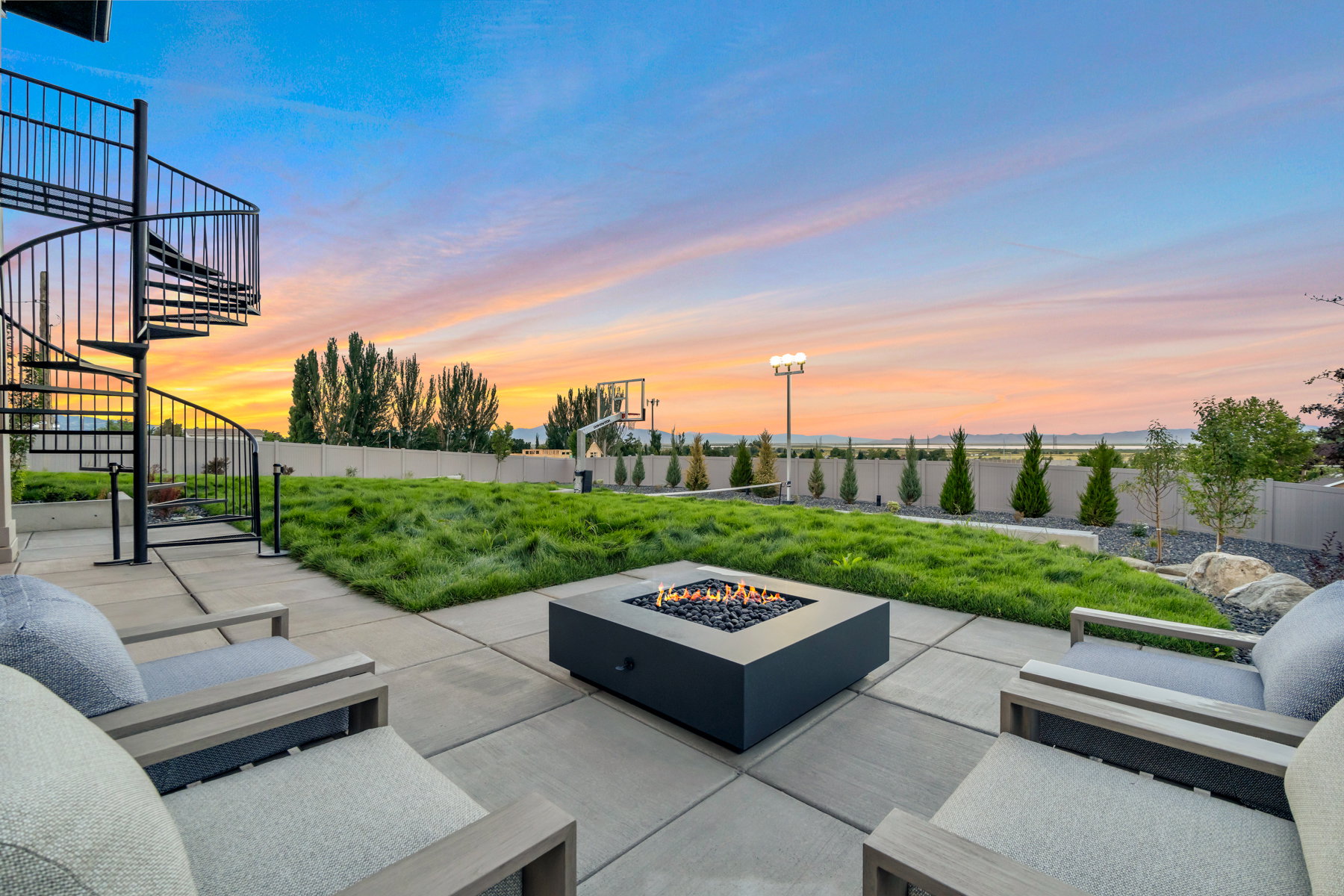 Fenced backyard with stairs and an outdoor living space with a fire pit