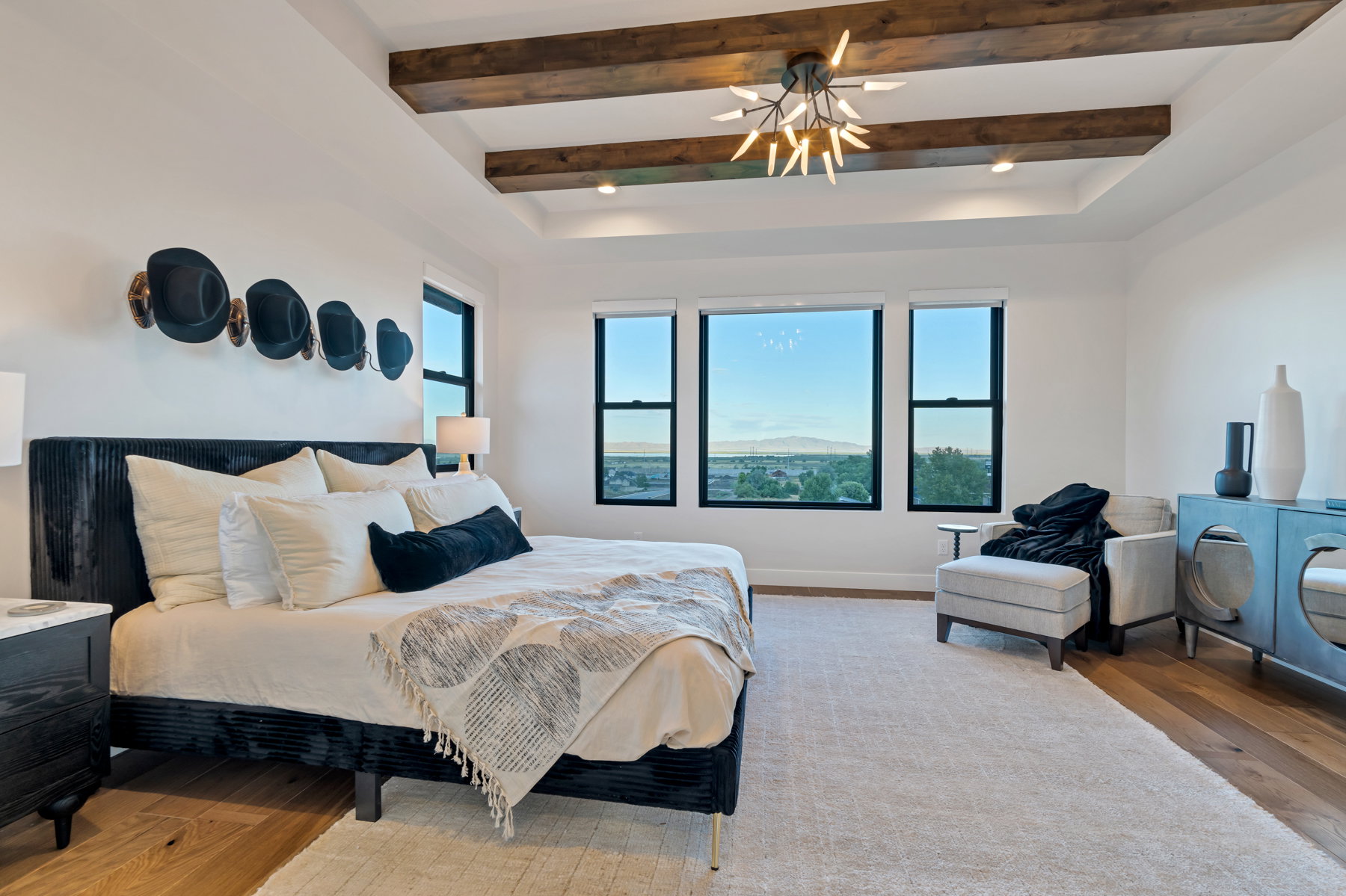 Bedroom with wood-type flooring, beam ceiling, and ceiling fan