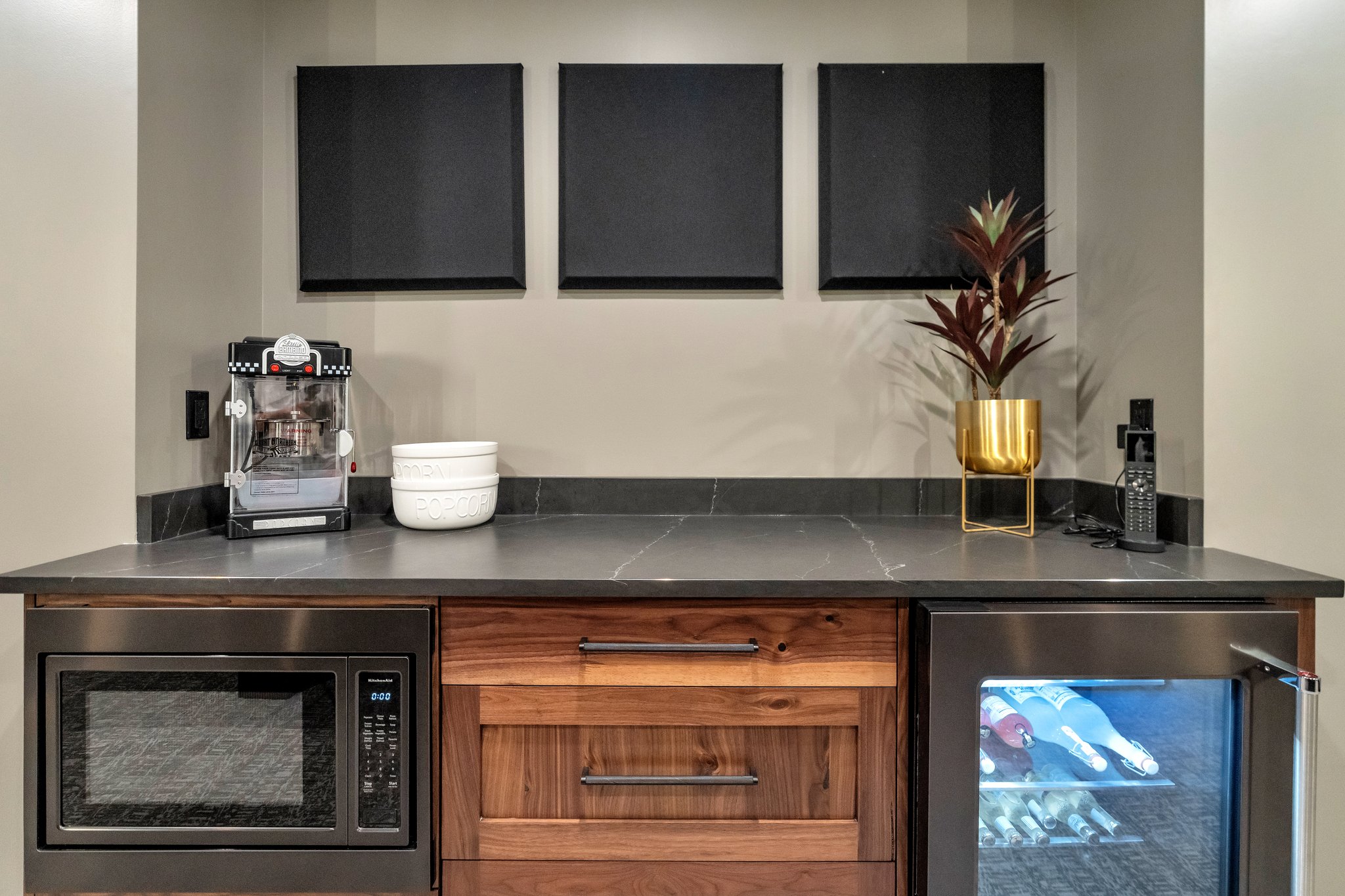 Bar with beverage cooler, stainless steel microwave, dark stone counters, and wood finish cabinetry