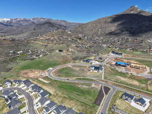 Aerial view of property's location with nearby suburban area and mountains