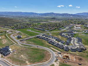 View of property location with a mountain backdrop and nearby suburban area