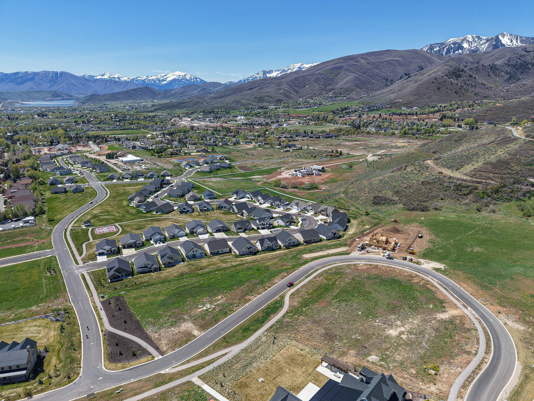 Aerial overview of property's location with a mountainous background and nearby suburban area