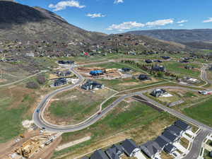 Aerial view of property's location featuring nearby suburban area and mountains