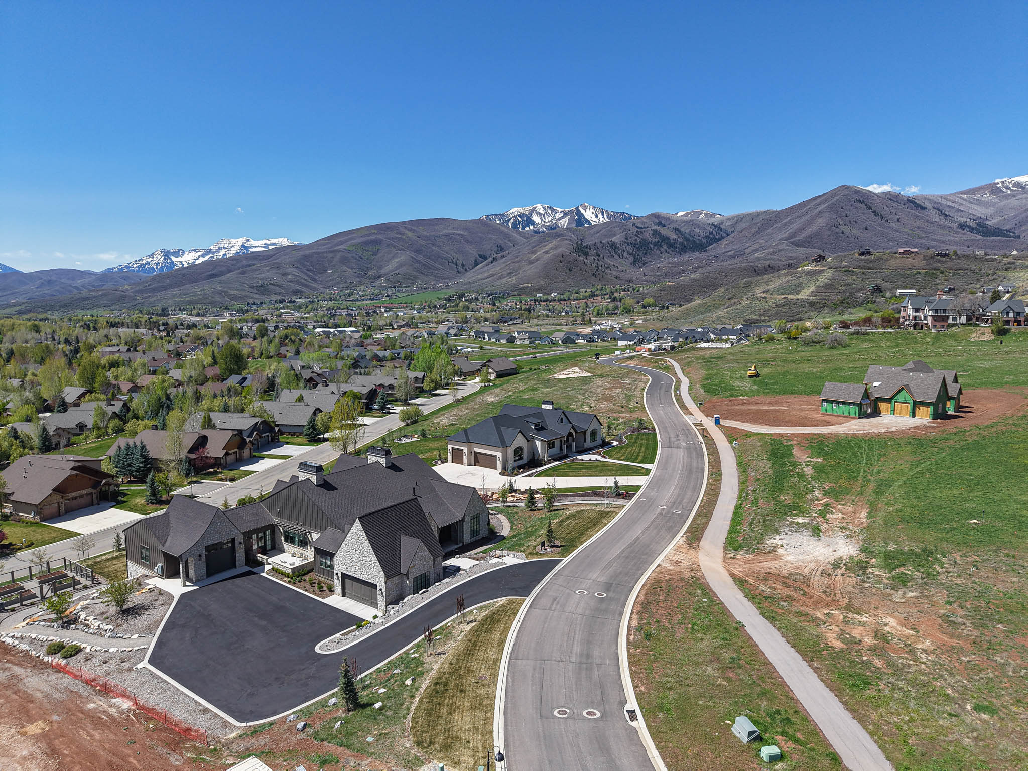 Aerial view of property's location with a mountain backdrop and nearby suburban area