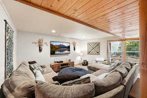 Living area with wood ceiling, recessed lighting, and wood finished floors