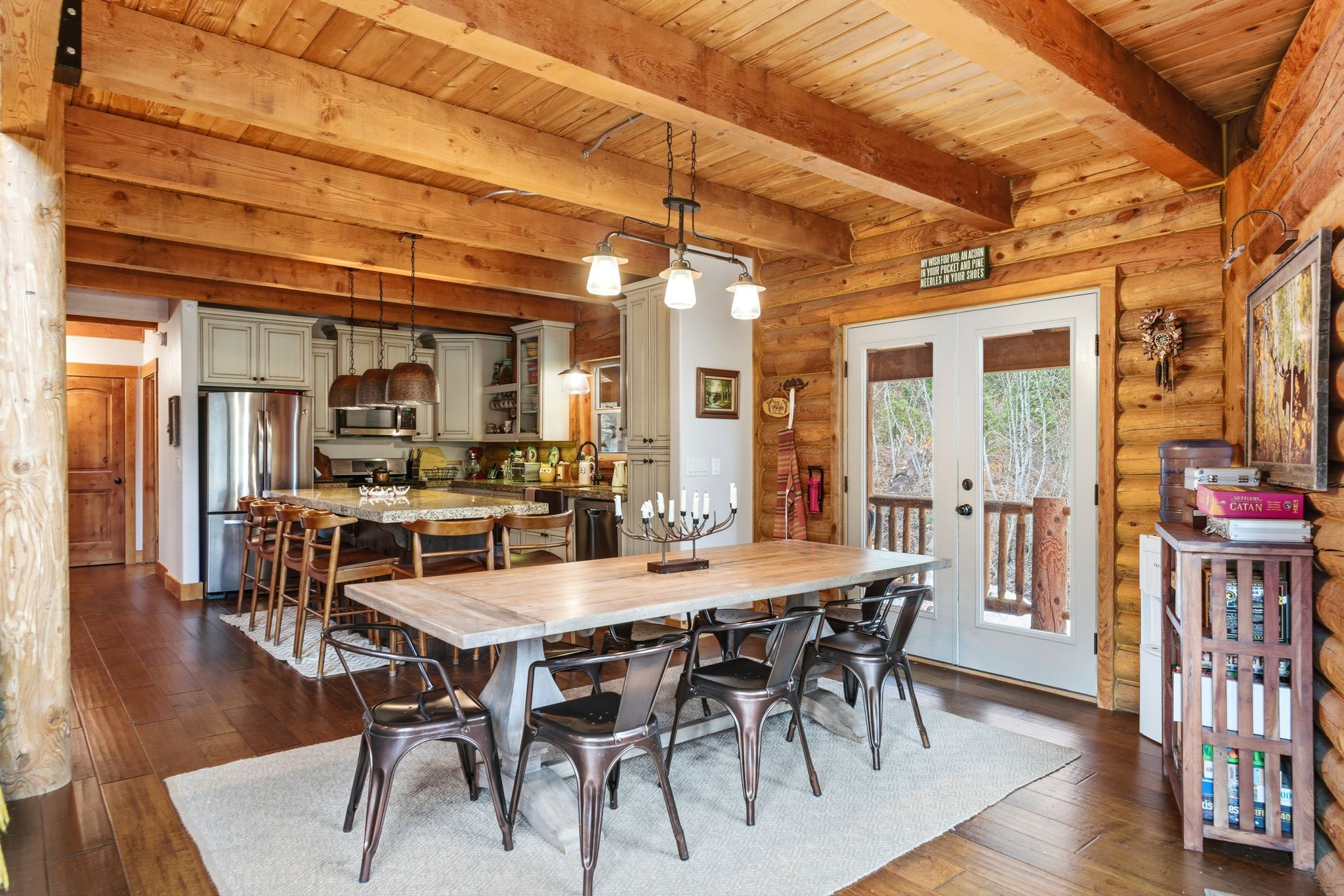 Dining space featuring french doors, dark wood-style floors, rustic walls, and a wooden ceiling with exposed beams