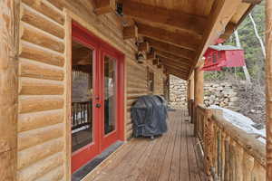 Wooden deck featuring french doors and grilling area