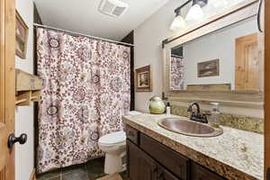 Full bath featuring vanity, a shower with curtain, and a textured ceiling