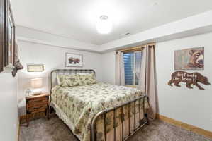 Carpeted bedroom with baseboards