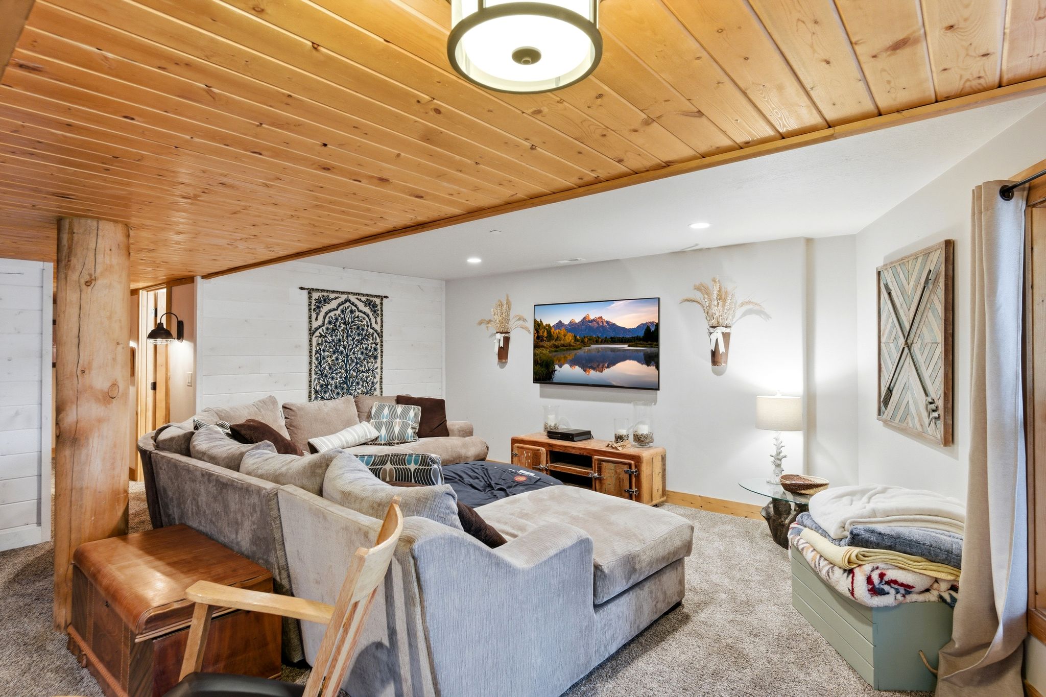 Carpeted living room featuring wood ceiling, wood walls, and recessed lighting