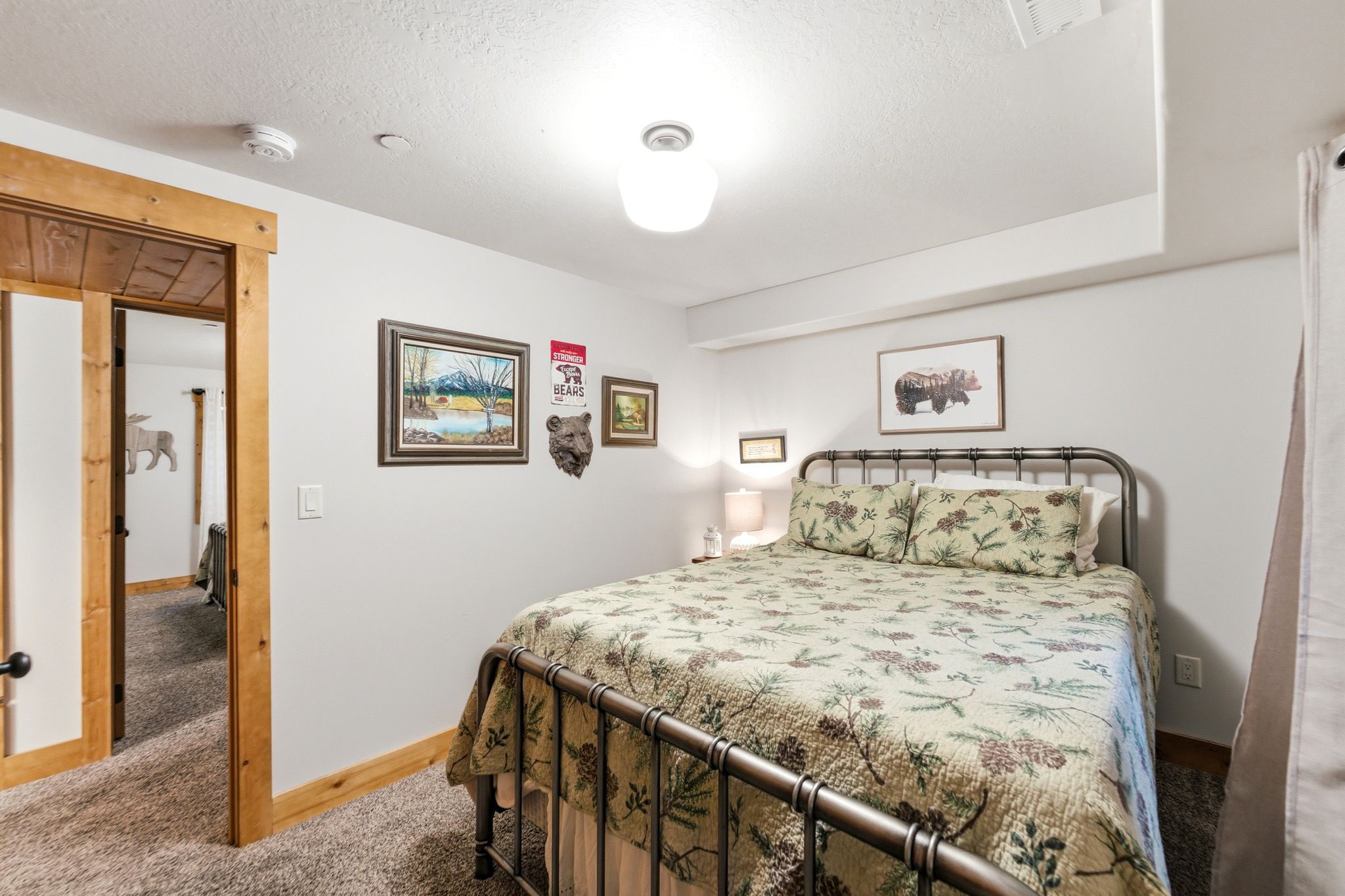 Carpeted bedroom featuring baseboards and a textured ceiling