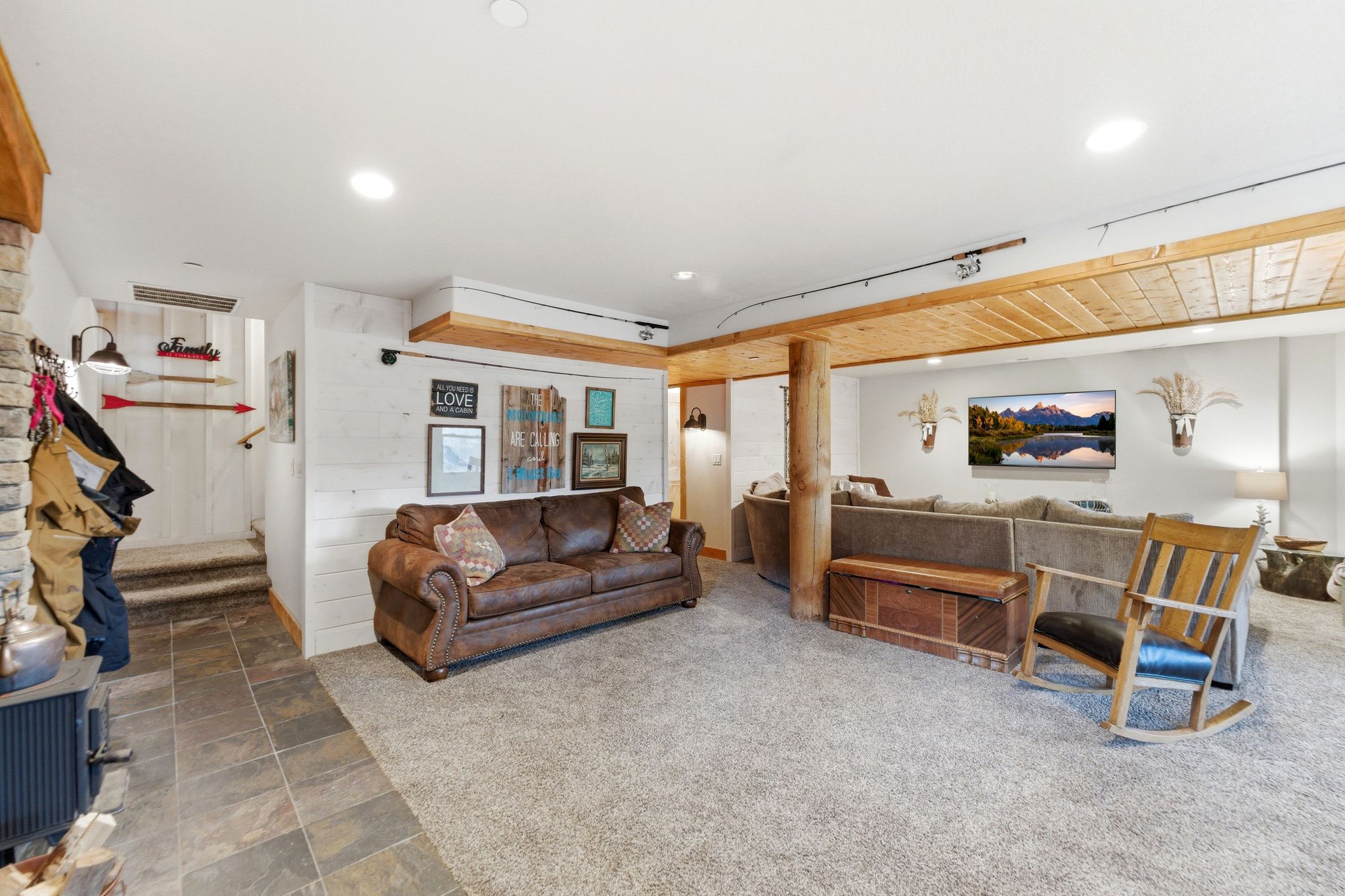 Living area with stone finish flooring, carpet, and recessed lighting