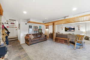 Living area with stone finish flooring, carpet, and recessed lighting