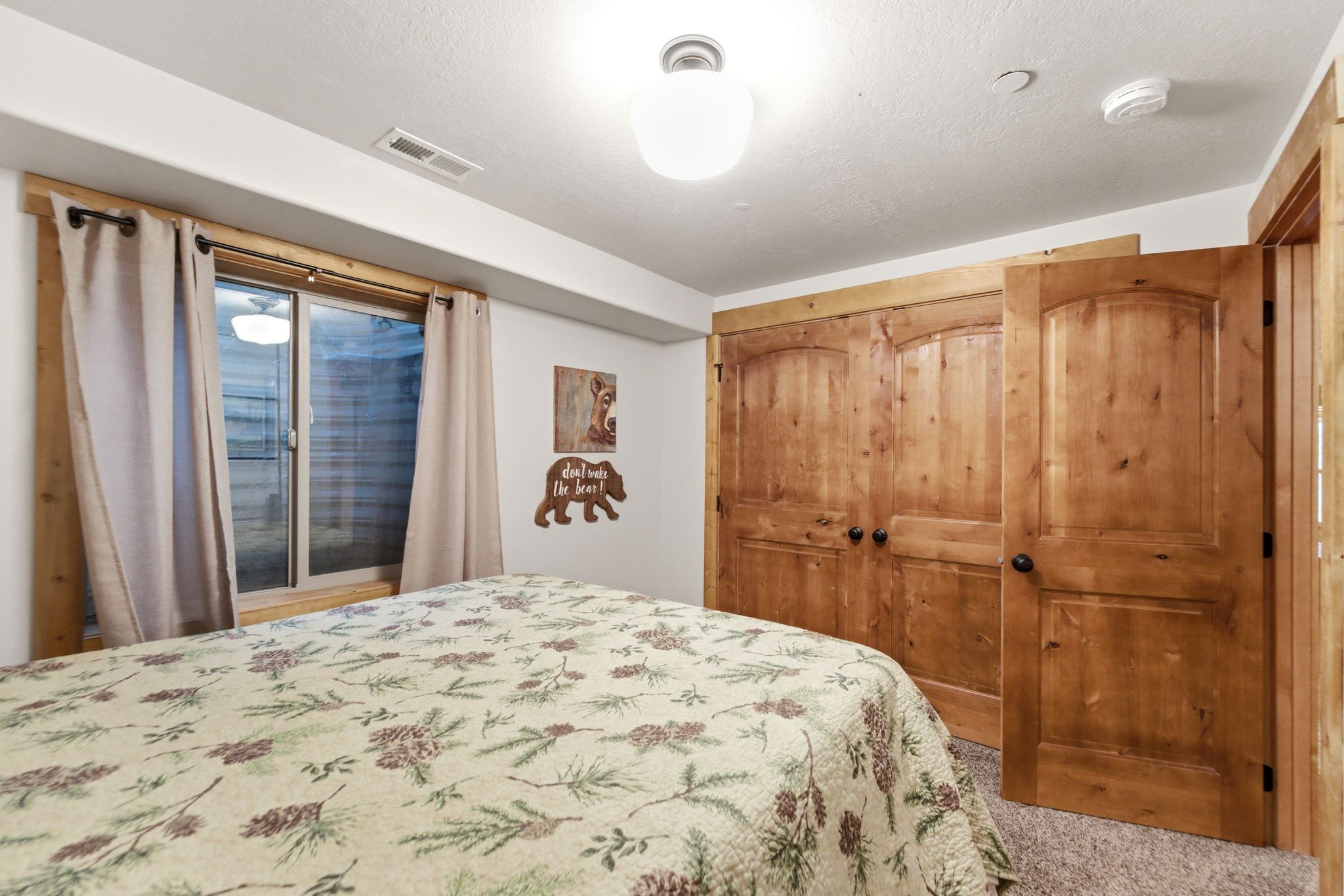 Bedroom with a closet, a textured ceiling, and carpet flooring