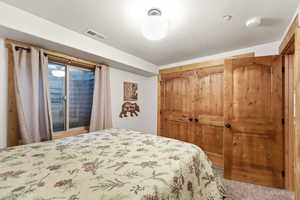 Bedroom with a closet, a textured ceiling, and carpet flooring