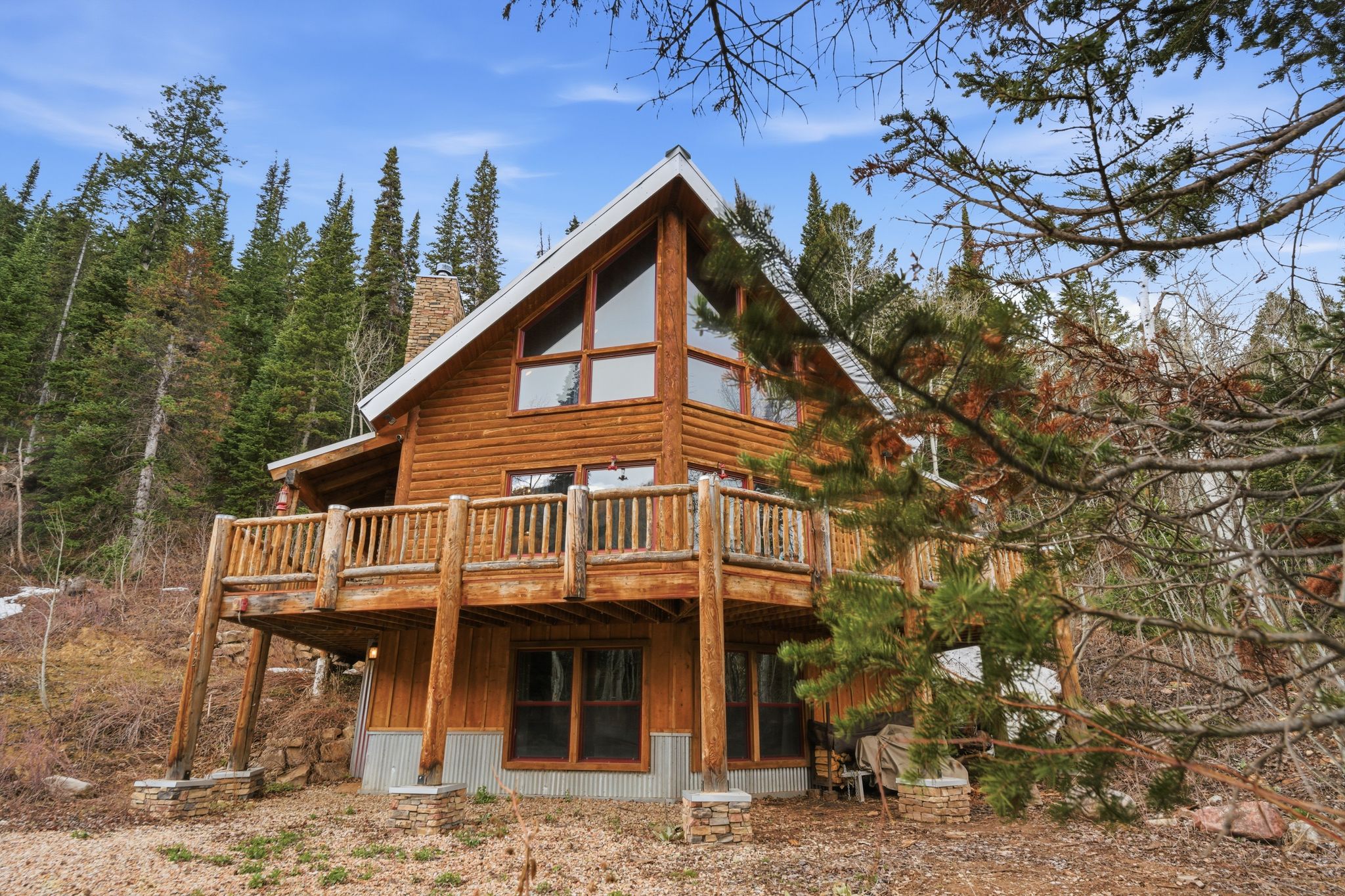 Back of house featuring a wooden deck and a chimney