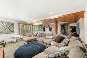 Living area featuring a wood stove and recessed lighting
