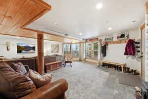 Living area featuring stone finish floors and recessed lighting