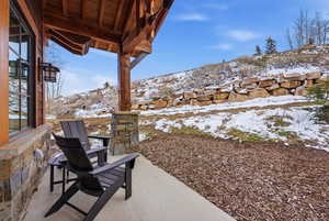 Snow covered patio with a patio and a mountain view