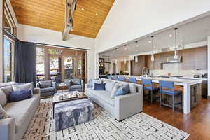 Living room with a vaulted wooden ceiling, dark wood finished floors, french doors, and recessed lighting