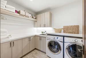 Laundry area with cabinet space and washer and dryer
