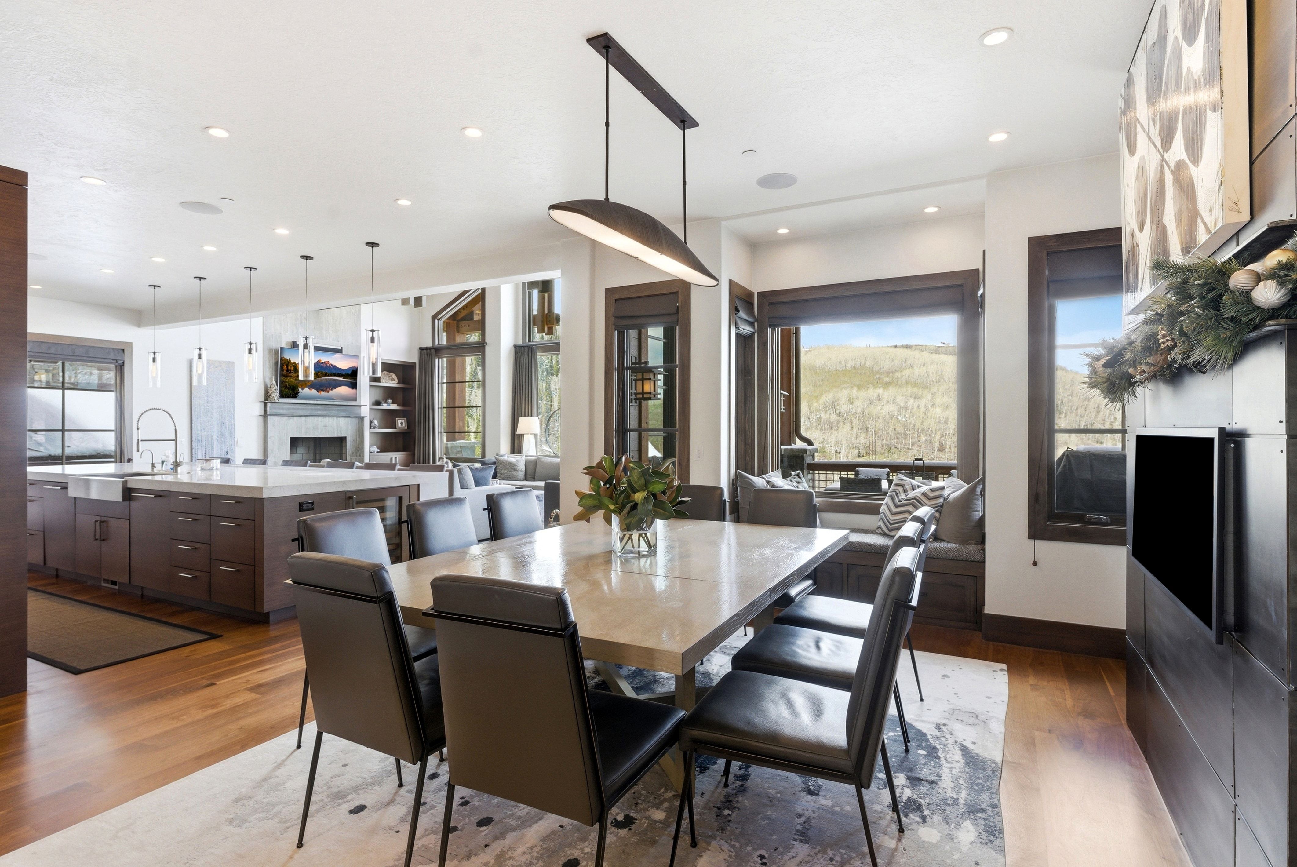 Dining space featuring dark wood finished floors, a fireplace, and recessed lighting