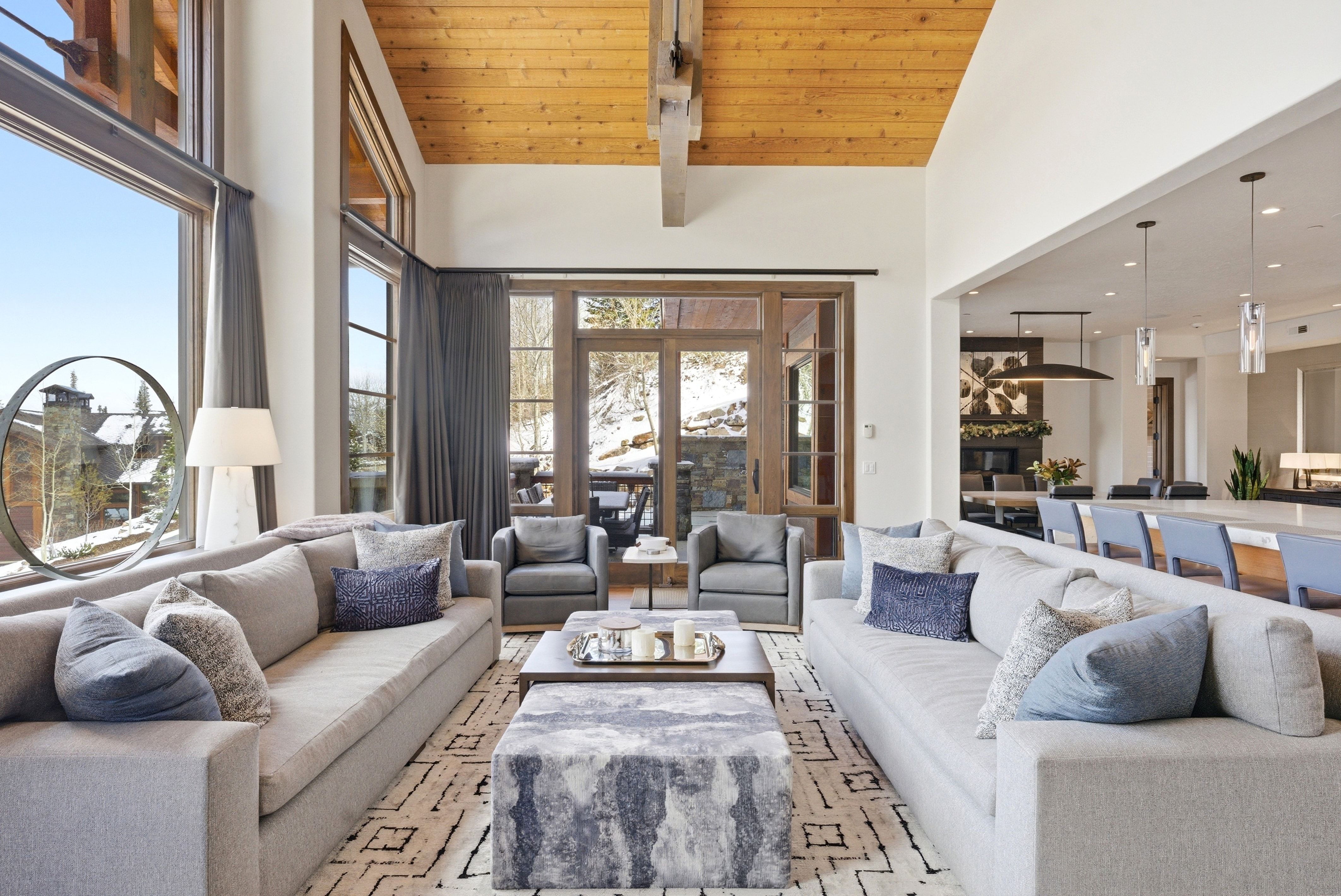 Living area with a high wooden ceiling and recessed lighting