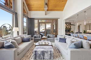 Living area with a high wooden ceiling and recessed lighting