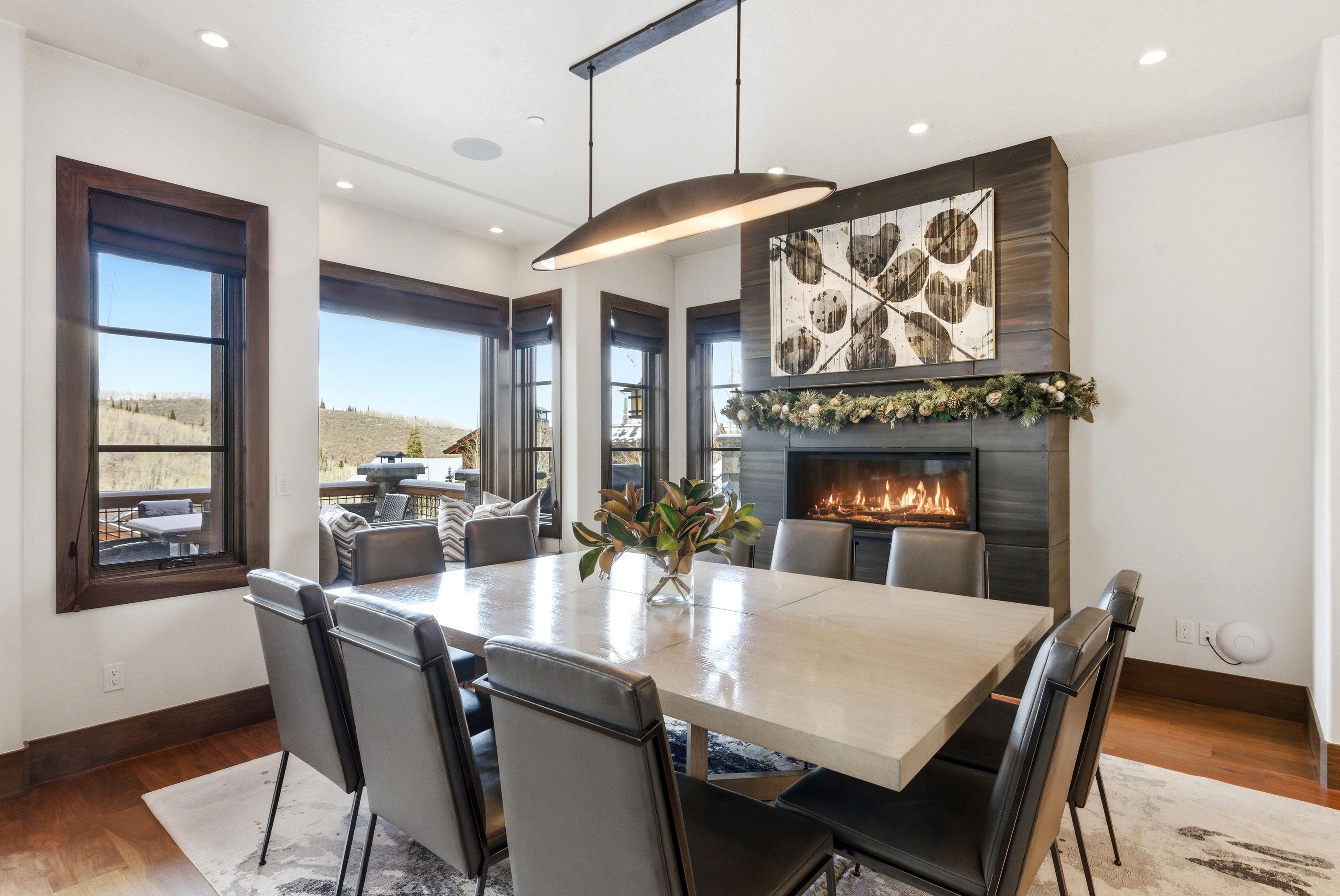 Dining space with wood finished floors, healthy amount of natural light, a fireplace, and recessed lighting