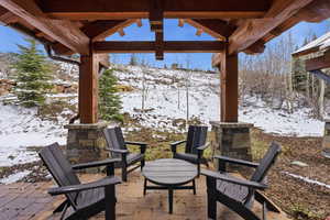 Snow covered patio with a patio