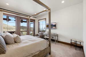 Bedroom with access to outside, light carpet, and recessed lighting