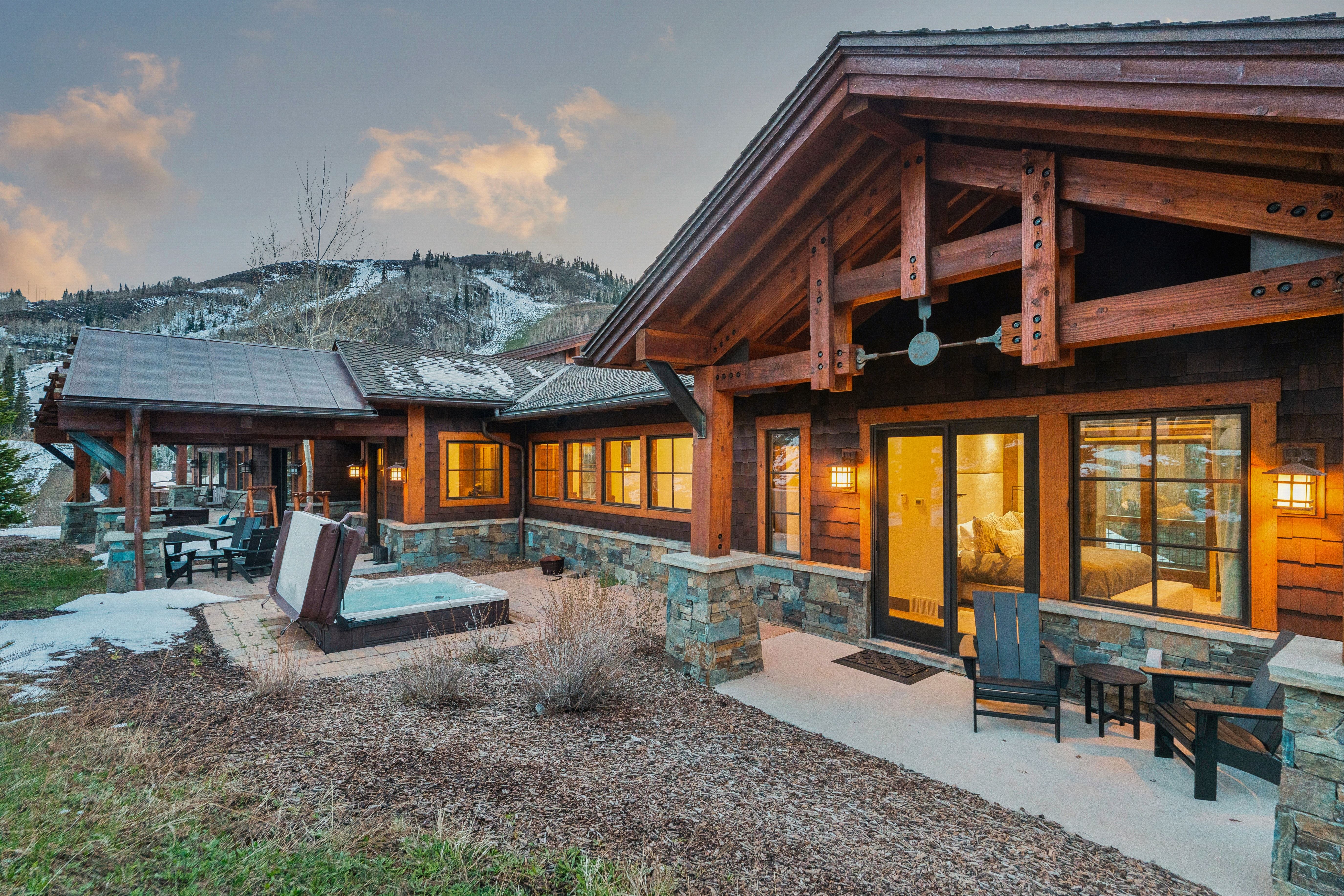 Back of house featuring a patio area, stone siding, and a mountain view