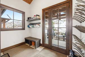 Mudroom with baseboards and wood ceiling