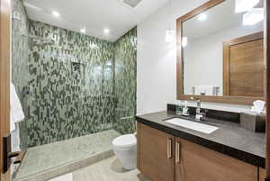 Bathroom with vanity, a stall shower, and recessed lighting