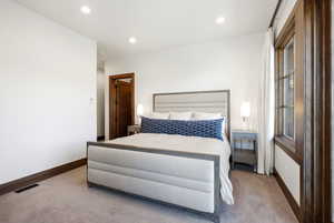 Carpeted bedroom featuring baseboards and recessed lighting